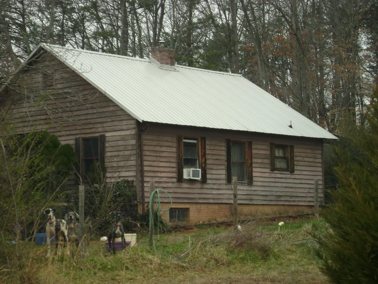 White metal roof on an old wood sided farmhouse, from a Metal Roof Installation job in Fairland